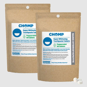 Two packages of CHOMP Super Whitening Toothpaste Tablets on a white background