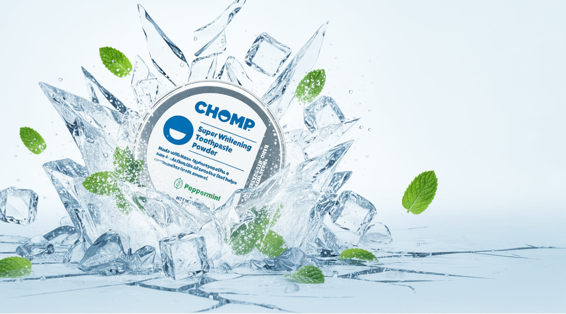 CHOMP peppermint toothpaste powder surrounded by ice cubes and mint leaves on a light blue background