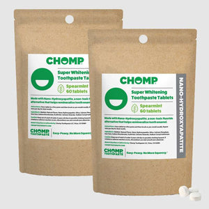 Two packages of CHOMP Super Whitening Toothpaste Tablets on a white background