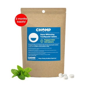 CHOMP Super Whitening Toothpaste Tablets packaging with peppermint leaves on a white background
