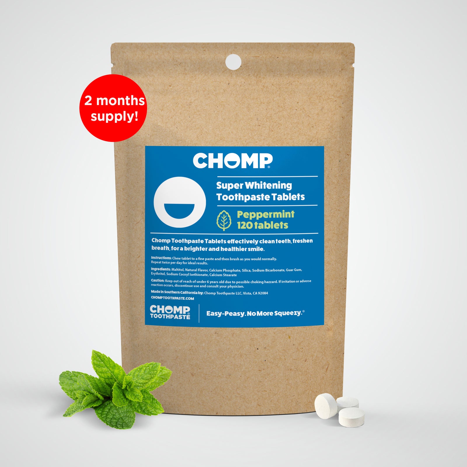 CHOMP Super Whitening Toothpaste Tablets packaging with peppermint leaves on a white background