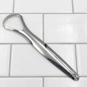 Metal bottle opener on a tiled surface
