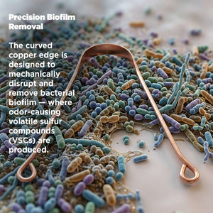 Copper tongue scrapper on a textured surface with text about biofilm removal.