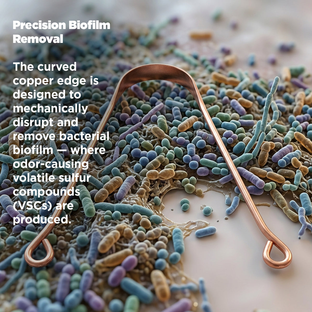 Copper tongue scrapper on a textured surface with text about biofilm removal.