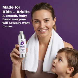 Woman holding a bottle of mouthwash with a child, against a purple background