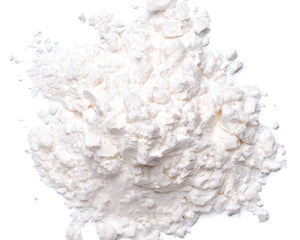 A pile of fine white powder, likely cornstarch or talc, photographed from directly above on a solid white background.